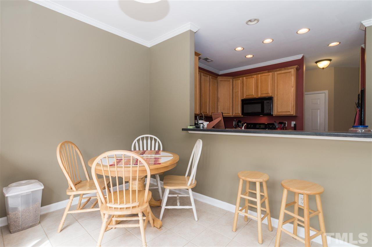 8417 Whisper Ridge Place Raleigh, NC 27613 - Photo 9 of 24 a dining room with furniture and a chandelier