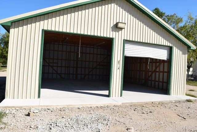 a view of a house with a door and wooden roof