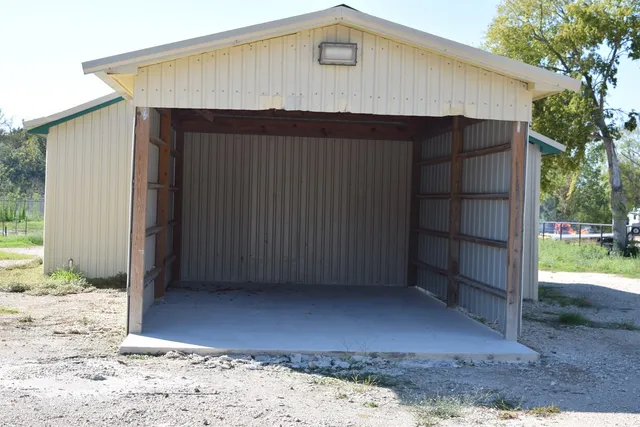 a view of a house with a wooden fence