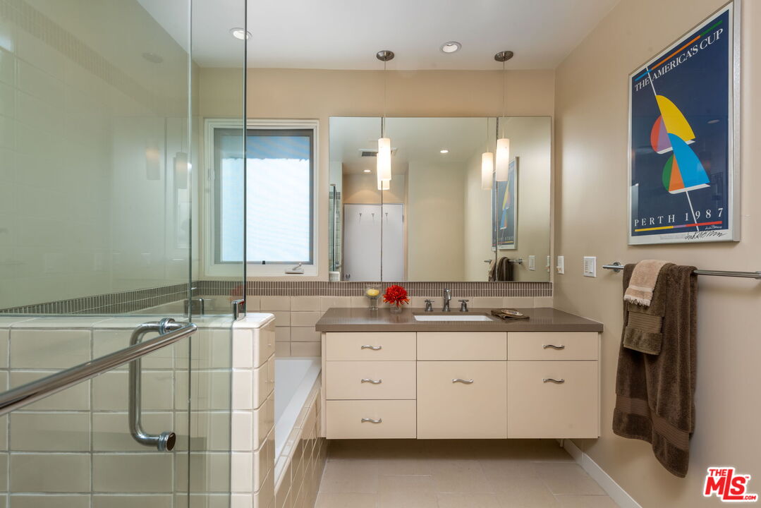 657 Hightree Road Santa Monica, CA 90402 - Photo 17 of 31 a bathroom with a double vanity sink and a mirror