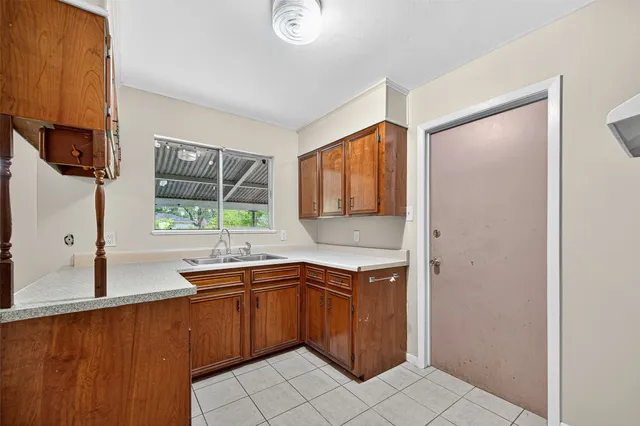 a kitchen with a sink cabinets and window
