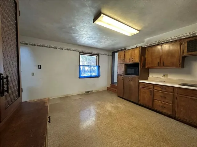 a view of a kitchen with microwave and cabinets