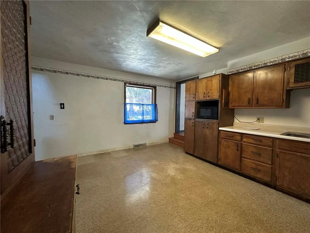 235 Hinchberger Road Butler, PA 16002 - Photo 14 of 40 a view of a kitchen with microwave and cabinets