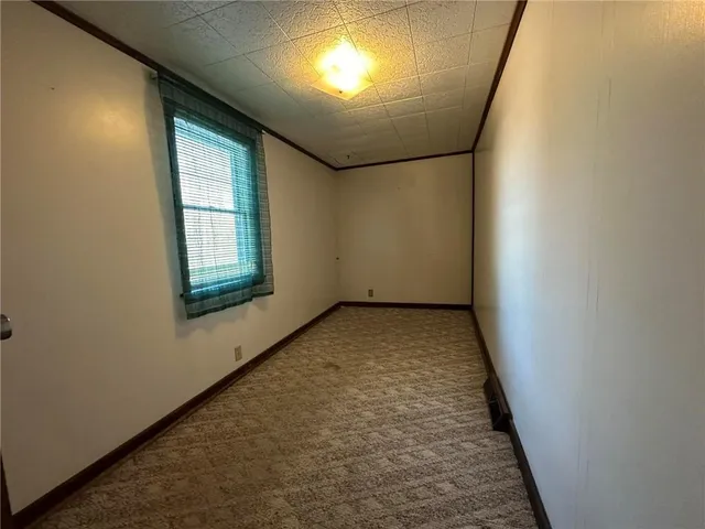 a view of a big room with closet and windows