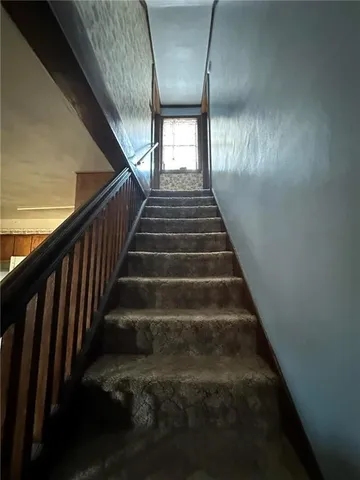 a bedroom with a bed and a mirror