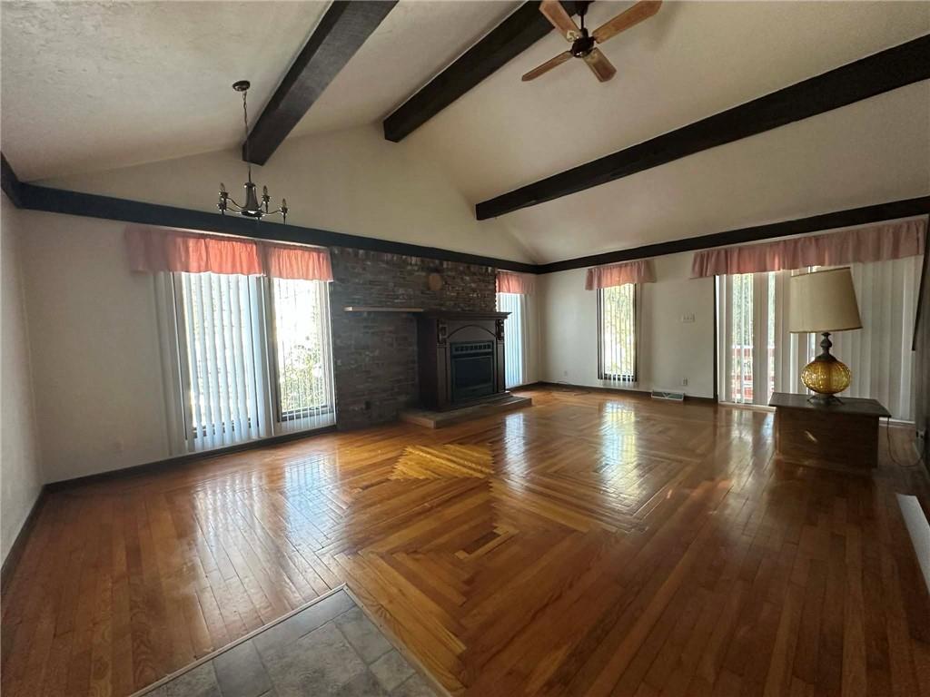 235 Hinchberger Road Butler, PA 16002 - Photo 9 of 40 a view of empty room with wooden floor and fireplace