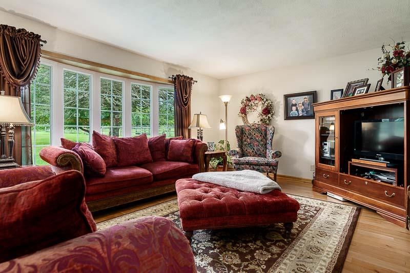 8410 Forest Preserve Road Durand, IL 61024 - Photo 11 of 37 a living room with furniture a window and a flat screen tv