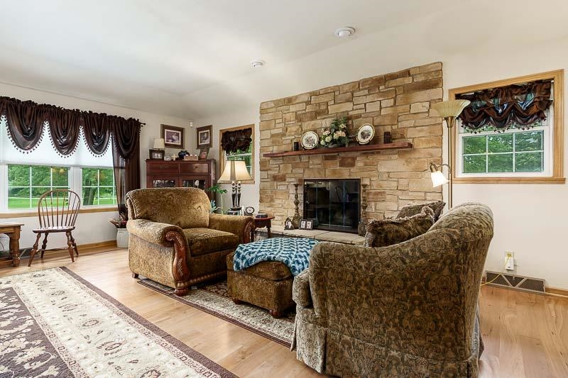 8410 Forest Preserve Road Durand, IL 61024 - Photo 12 of 37 a living room with furniture and a fireplace