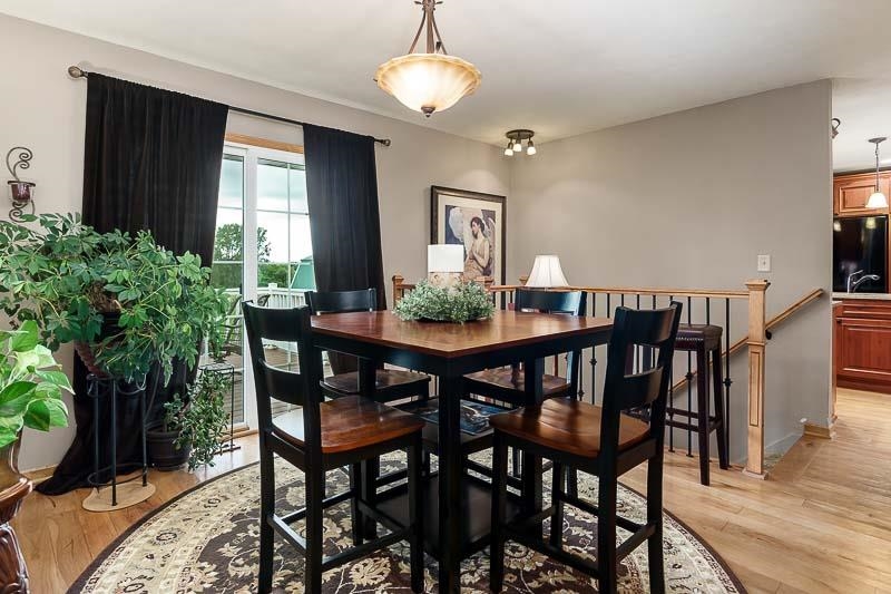 8410 Forest Preserve Road Durand, IL 61024 - Photo 13 of 37 a view of a dining room with furniture and wooden floor