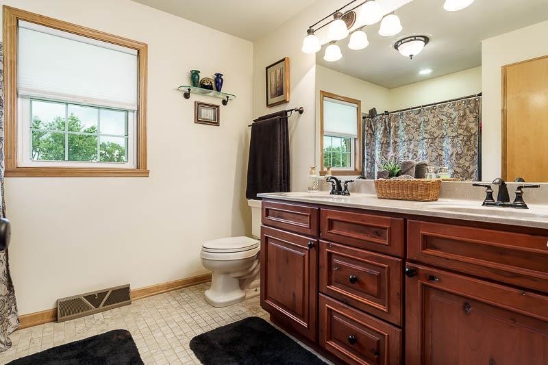 8410 Forest Preserve Road Durand, IL 61024 - Photo 17 of 37 a bathroom with a toilet sink and mirror
