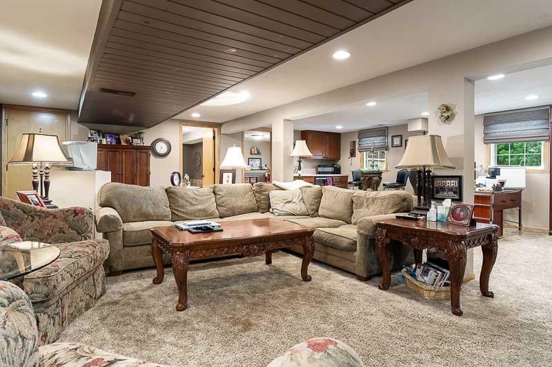 8410 Forest Preserve Road Durand, IL 61024 - Photo 19 of 37 a living room with furniture a rug and a chandelier