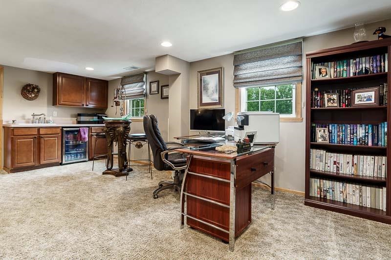 8410 Forest Preserve Road Durand, IL 61024 - Photo 21 of 37 a view of a workspace with furniture and a bookshelf