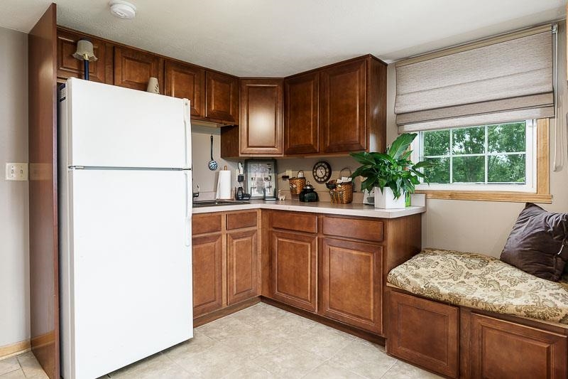 8410 Forest Preserve Road Durand, IL 61024 - Photo 25 of 37 a kitchen with stainless steel appliances granite countertop a refrigerator and a sink