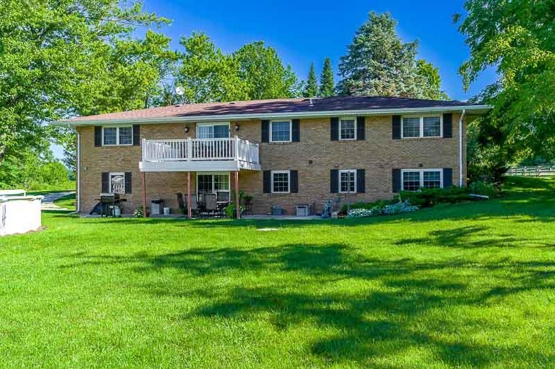 8410 Forest Preserve Road Durand, IL 61024 - Photo 26 of 37 a front view of a house with a garden