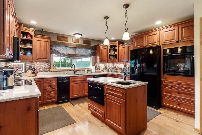 8410 Forest Preserve Road Durand, IL 61024 - Photo 4 of 37 a kitchen with stainless steel appliances granite countertop a stove and a sink