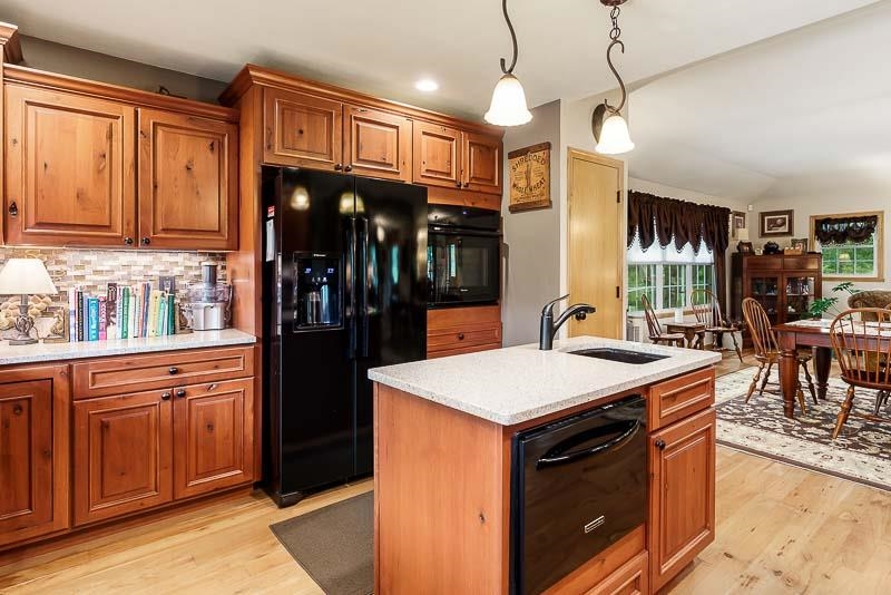 8410 Forest Preserve Road Durand, IL 61024 - Photo 5 of 37 a kitchen with stainless steel appliances granite countertop a sink a stove and a refrigerator