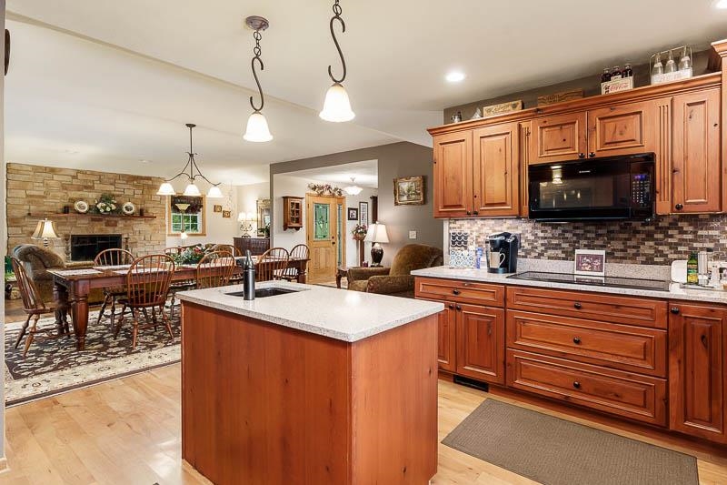 8410 Forest Preserve Road Durand, IL 61024 - Photo 6 of 37 a kitchen with stainless steel appliances granite countertop a sink a stove counter space and a view of living room