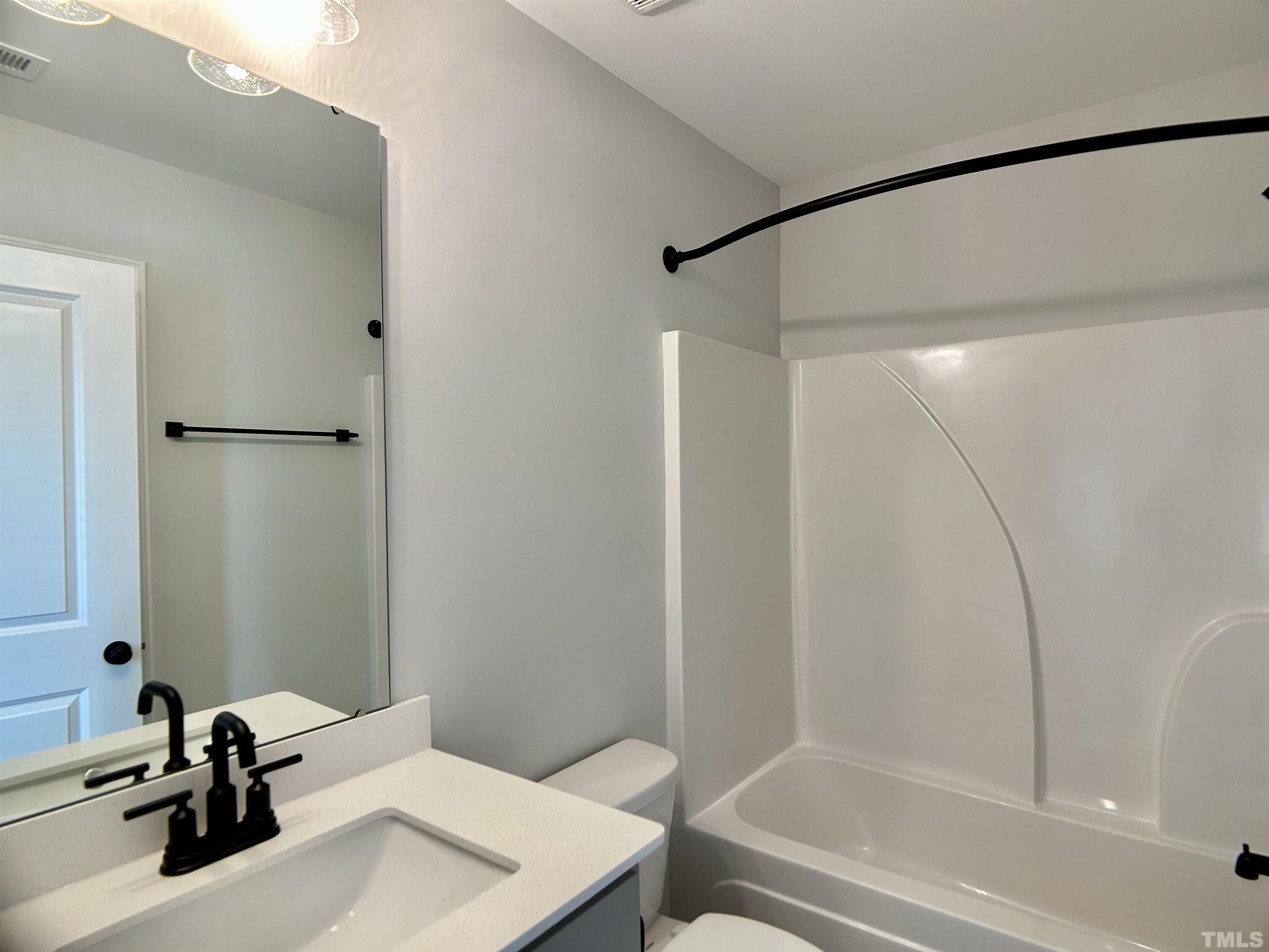 150 Greenview Street Clayton, NC 27520 - Photo 12 of 23 a bathroom with a sink and a mirror