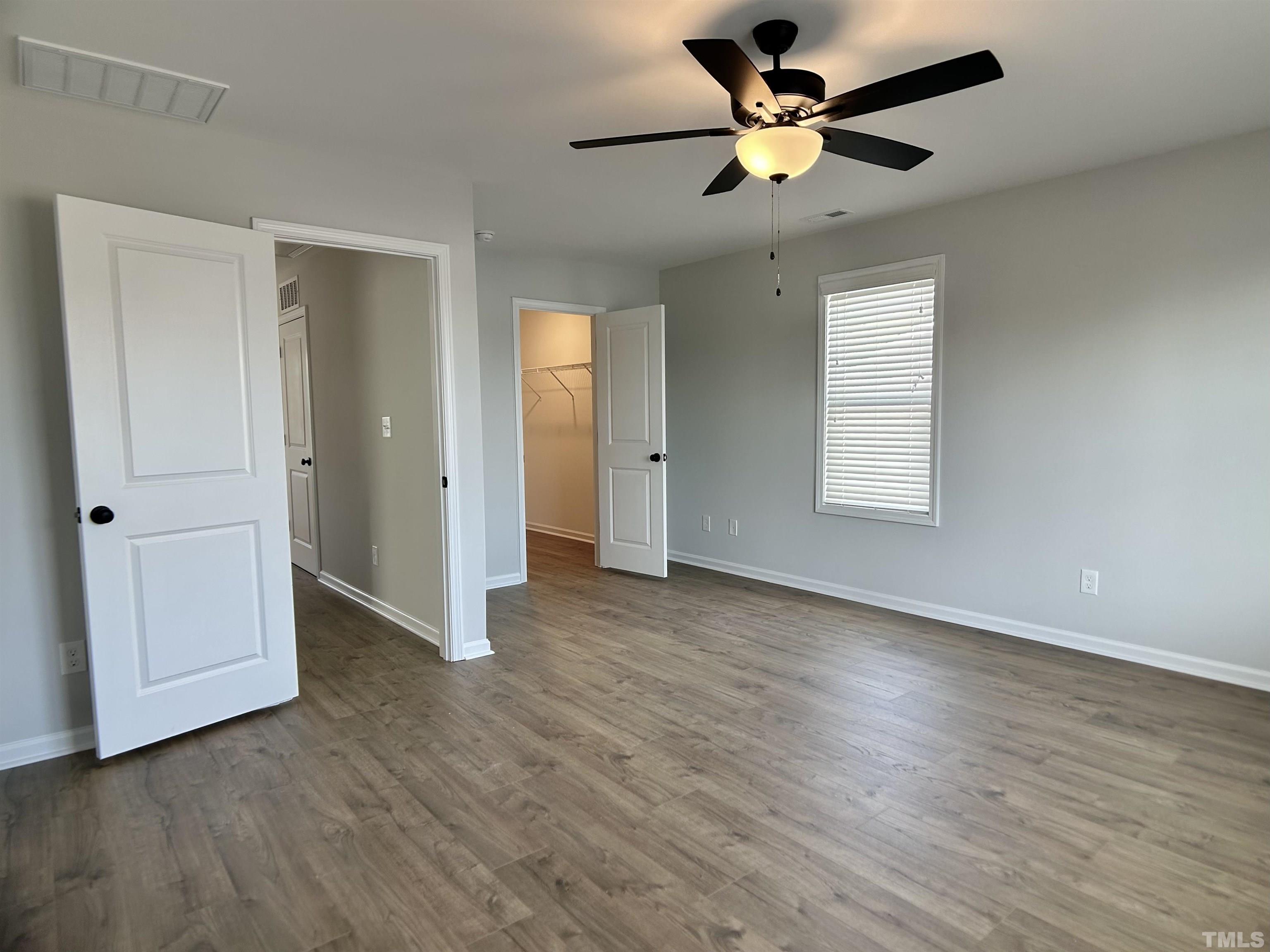 150 Greenview Street Clayton, NC 27520 - Photo 8 of 23 a view of an empty room with a window and wooden floor