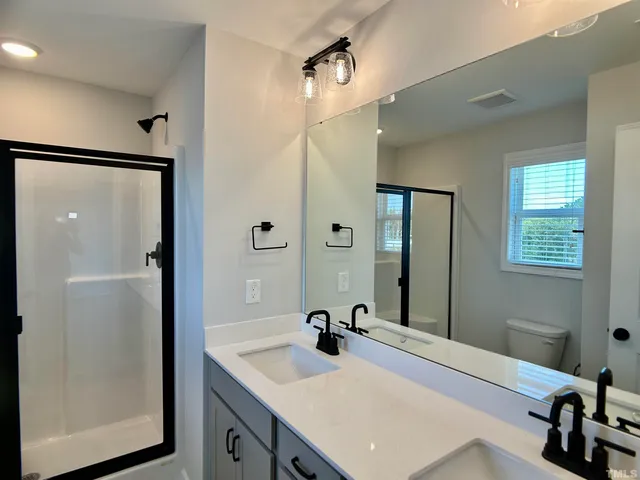 a bathroom with a sink double vanity and a mirror
