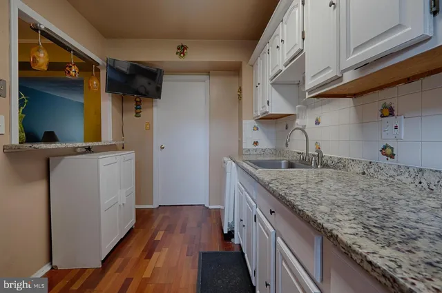 a kitchen with sink and cabinets