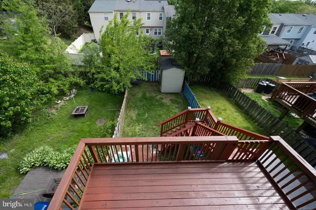 a view of a wooden deck and a yard with seating space