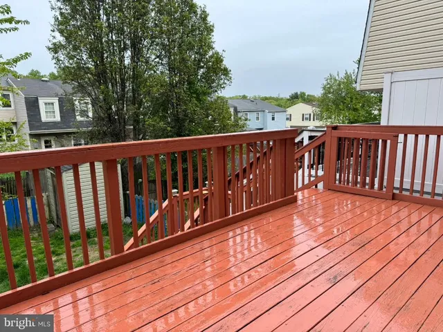 a balcony with wooden floor and fence