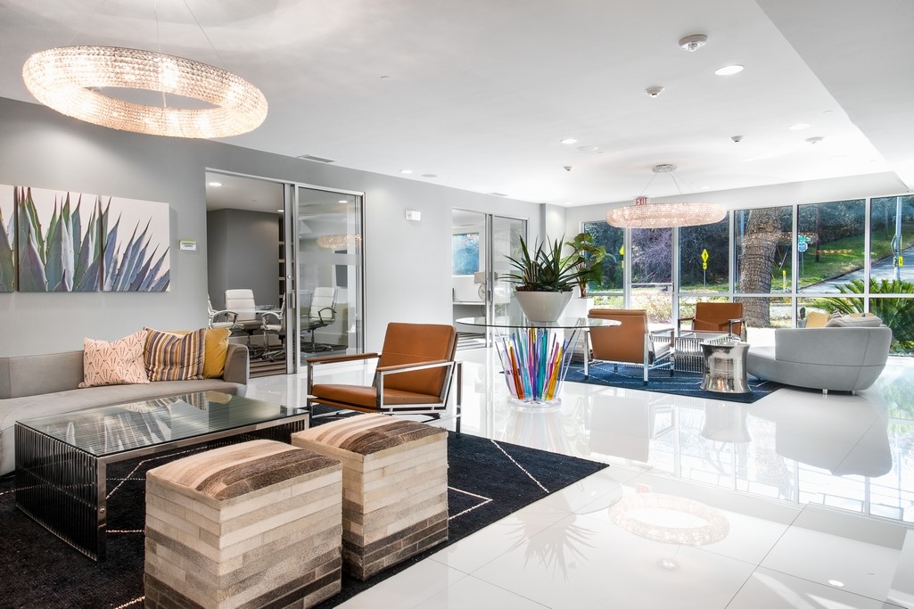 1900 Barton Springs Road, Unit 4029 Austin, TX 78704 - Photo 13 of 21 Gleaming polished tile floors reflect light in an open space featuring floor-to-ceiling windows.