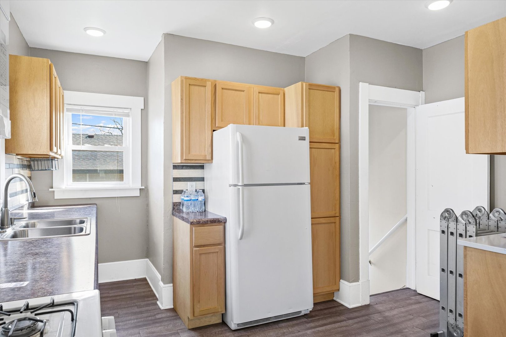 1311 West Hill Street Champaign, IL 61821 - Photo 12 of 27 a white refrigerator freezer sitting in a kitchen with stainless steel appliances granite countertop a refrigerator and a stove top oven