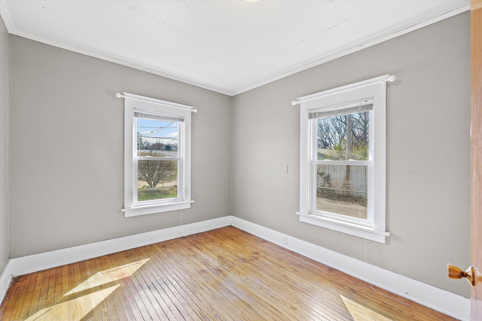1311 West Hill Street Champaign, IL 61821 - Photo 15 of 27 a view of an empty room with wooden floor and a window