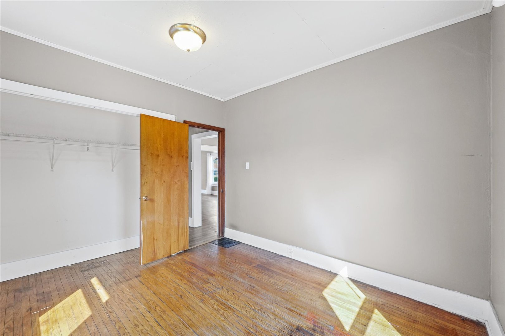 1311 West Hill Street Champaign, IL 61821 - Photo 16 of 27 a view of an empty room with wooden floor and a window