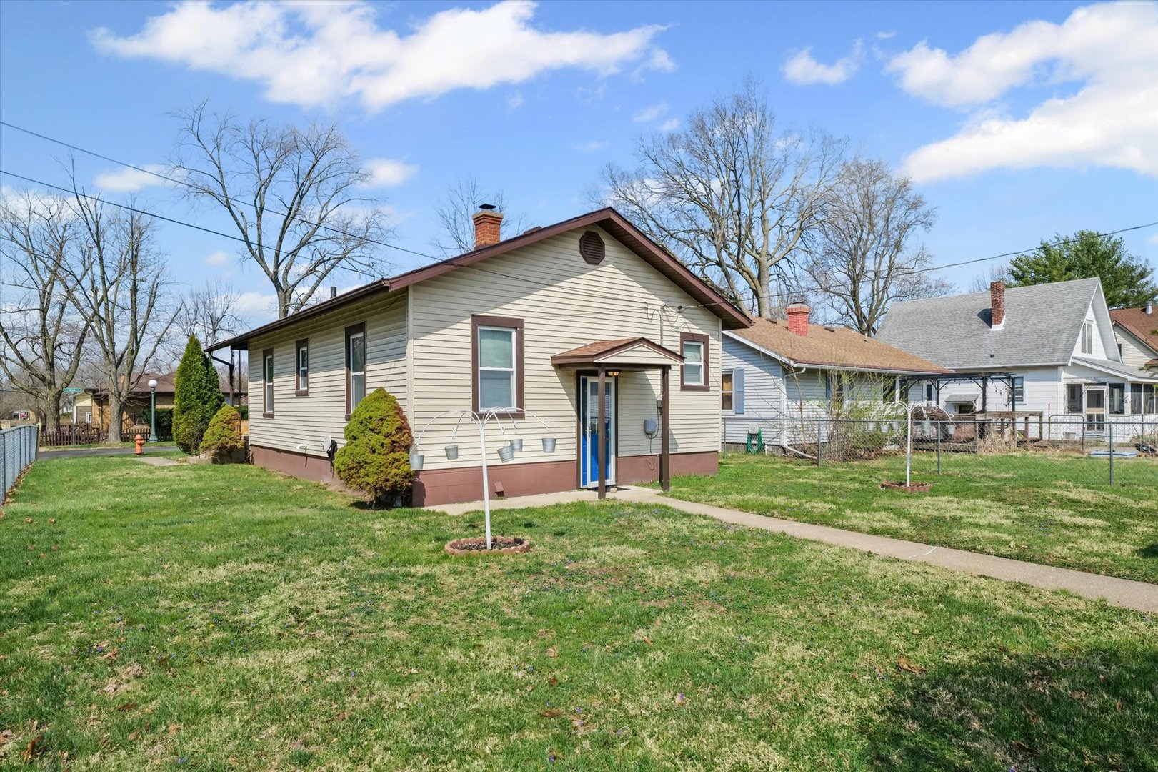 1311 West Hill Street Champaign, IL 61821 - Photo 23 of 27 a front view of a house with a yard and trees