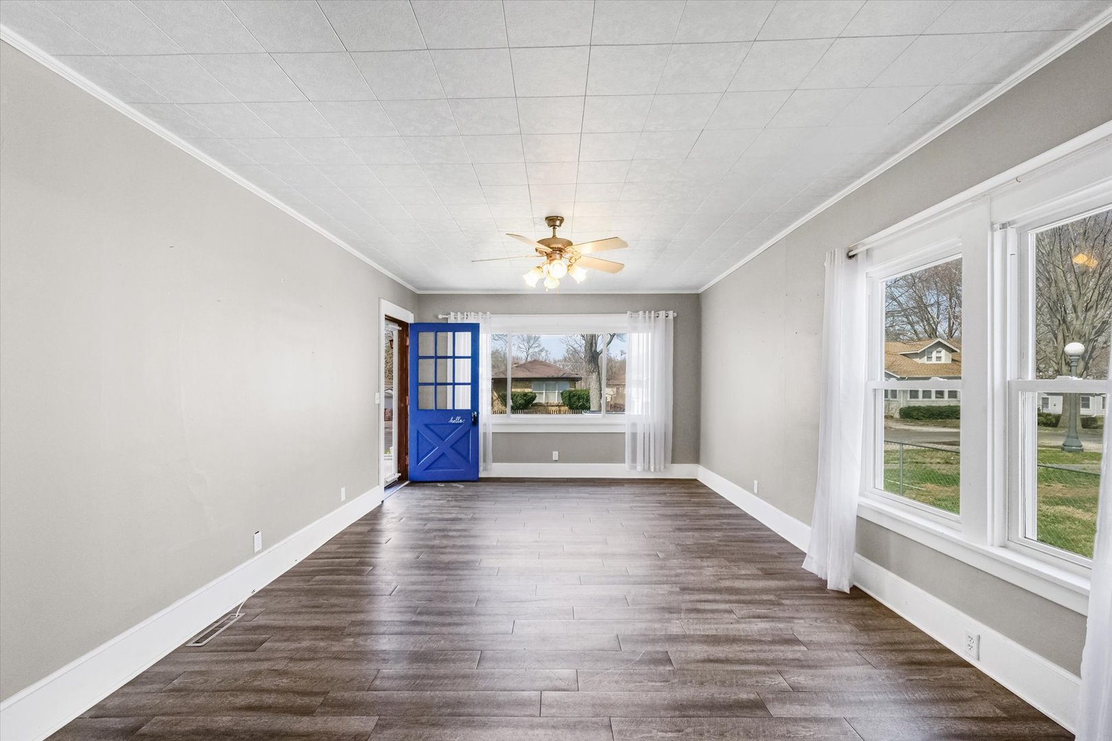1311 West Hill Street Champaign, IL 61821 - Photo 7 of 27 a view of an empty room with wooden floor and a window