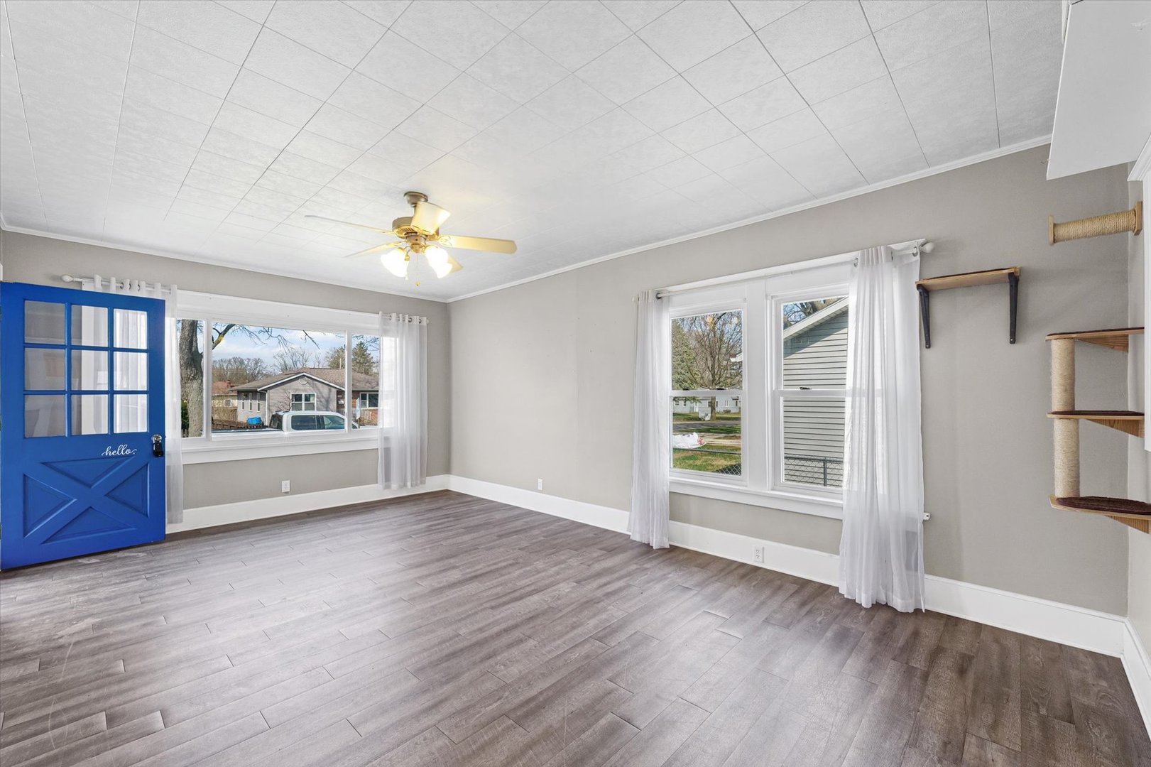 1311 West Hill Street Champaign, IL 61821 - Photo 8 of 27 a view of an empty room with a window and wooden floor