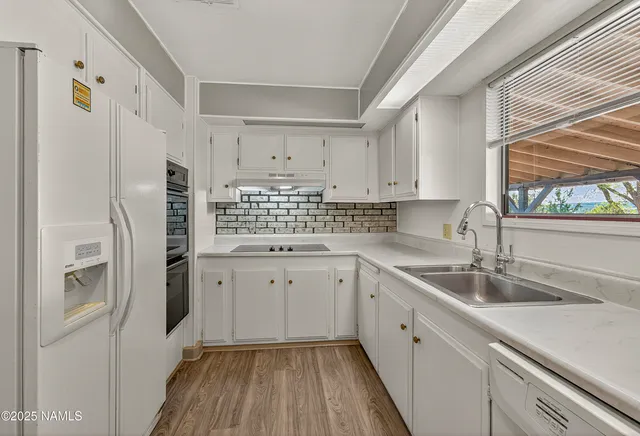 a front view of a house with a yard and potted plants