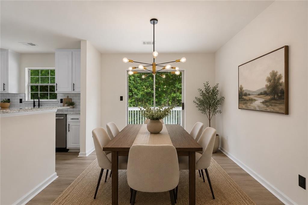 3602 Bristol Overlook Rex, GA 30273 - Photo 10 of 37 a dining room with furniture potted plants and wooden floor