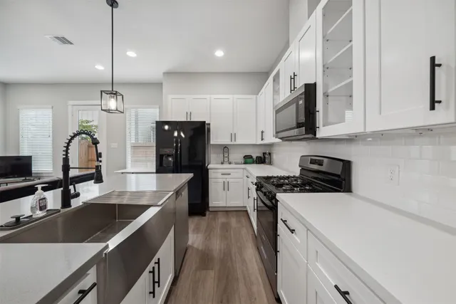 a kitchen with a sink stove and refrigerator
