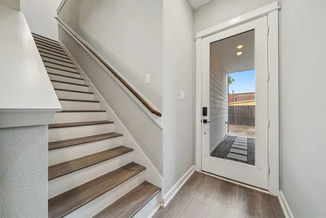 a view of a hallway with wooden floor and entryway