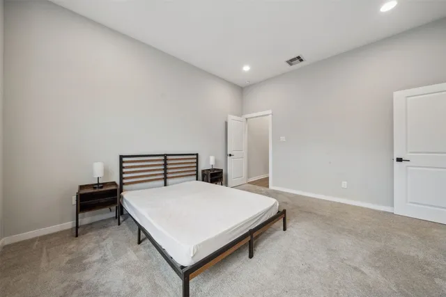 a bedroom with a bed and a table