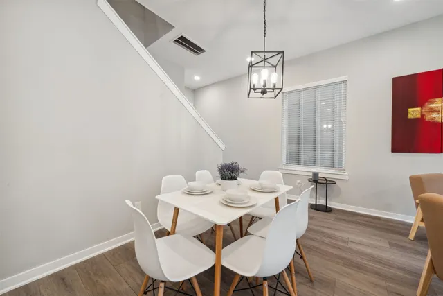 a view of a dining room with furniture wooden floor and chandelier