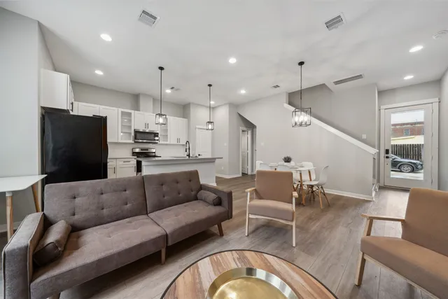a living room with furniture and kitchen view