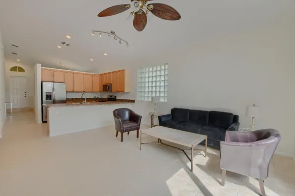 a living room with furniture and a kitchen view