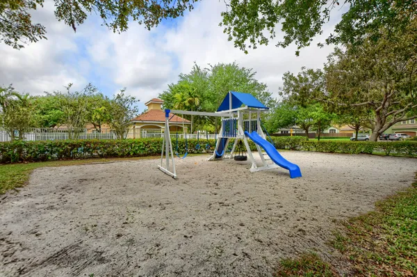 a view of outdoor space with playground and green space