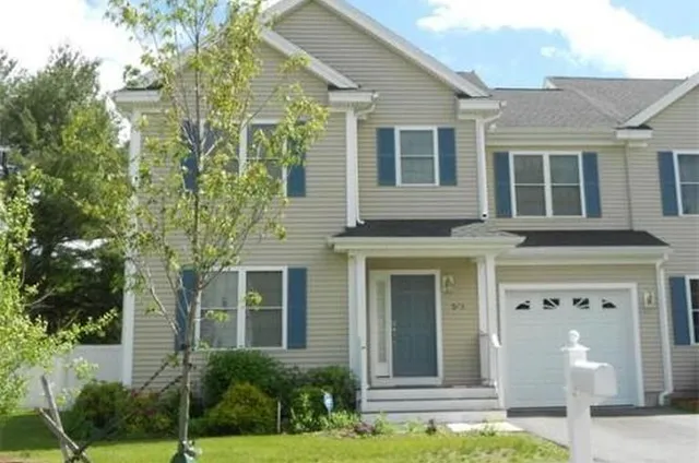 a front view of a house with a yard