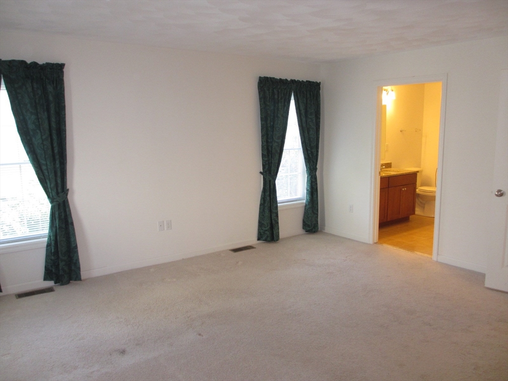 2 Blue Jay Circle, Unit 1 Wakefield, MA 01880 - Photo 4 of 11 an empty room with a fireplace and a window