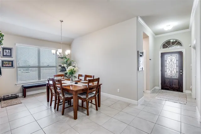 a view of a dining room with furniture and chandelier