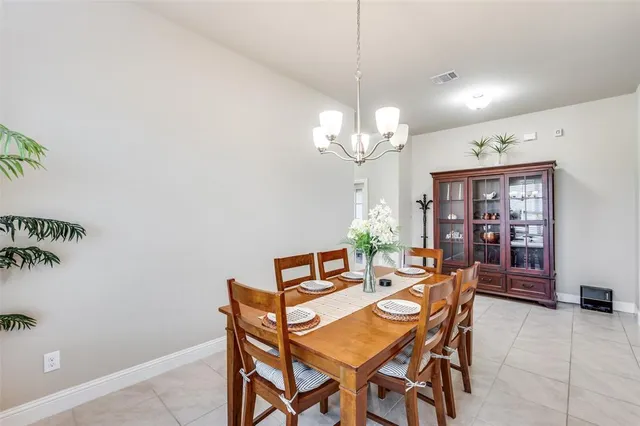 a view of a dining room with furniture and chandelier