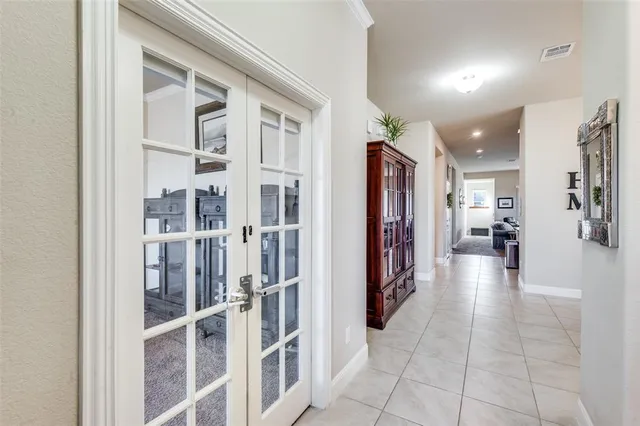 a view of a hallway with wooden shelves