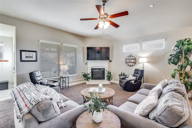 a living room with furniture a fireplace and a flat screen tv