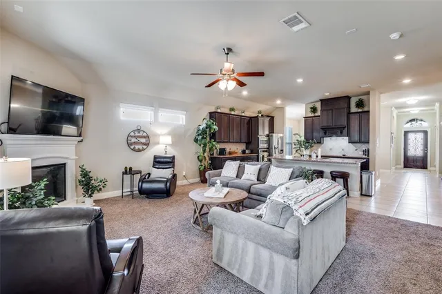 a living room with fireplace furniture and a flat screen tv